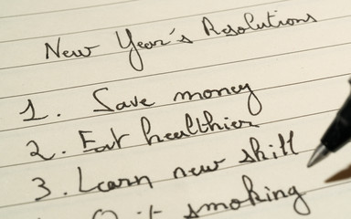 New Year's Resolutions list concept with a complete list on a notebook with a pen close up shot