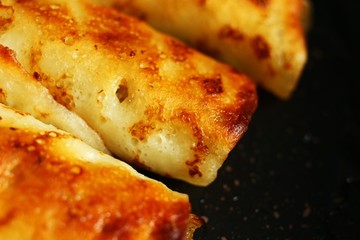 Pancakes stuffed with frying in a frying pan