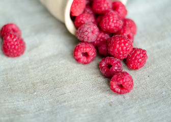 Fresh raspberry in a wooden plate with wooden spoon. Rustic style. Close up. Zero waste concept