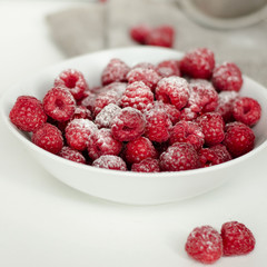 Fresh raspberry in a wooden plate with wooden spoon. Rustic style. Close up. Zero waste concept