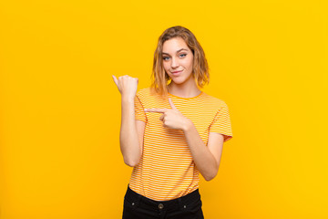 young blonde woman looking impatient and angry, pointing at watch, asking for punctuality, wants to...