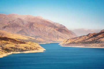 Aerial view of Charvak Lake or reservoir among mountains, Tashkent province, Uzbekistan