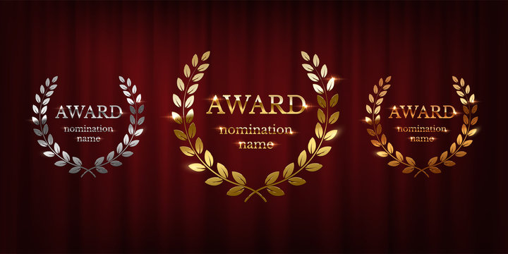Golden, silver and bronze award signs with laurel wreath isolated on red curtain background. Vector award design templates.
