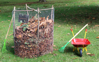 A wire cage for collecting fallen leaves to make leafmould or mulch for soil conditioning