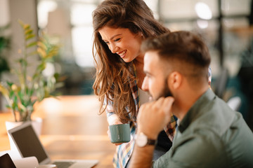 Colleagues in office. Businesswoman and businessman discussing work in office. Two friends in working together.  