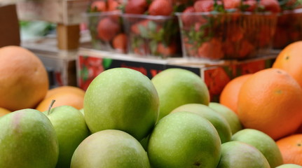 Apples and strawberries for sale. Various kind of organic vegetables in the market