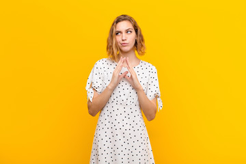 young blonde woman scheming and conspiring, thinking devious tricks and cheats, cunning and...