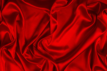 Obraz premium Red silk or satin luxury fabric texture can use as abstract background. Top view.