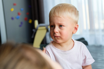 Portrait of a little blond boy with blue eyes