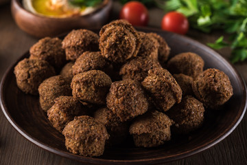 close up view of fresh cooked falafel balls on wooden table