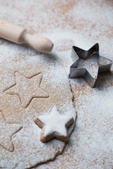 Ginger dough and other Christmas baking ingredients on the table. Star shape cookies preparation.
