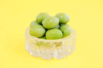natural round green olives in a decorative glass plate