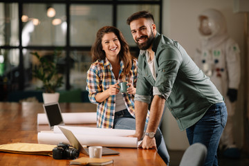 Businesswoman and businessman discussing work in office. Two friends in working together.  