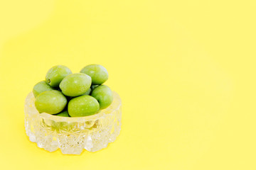 natural round green olives in a decorative glass plate