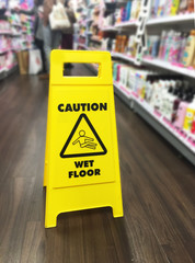 Selective focus of Wet floor caution warning sign at shopping mall