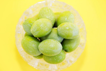 natural round green olives in a decorative glass plate