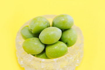 natural round green olives in a decorative glass plate