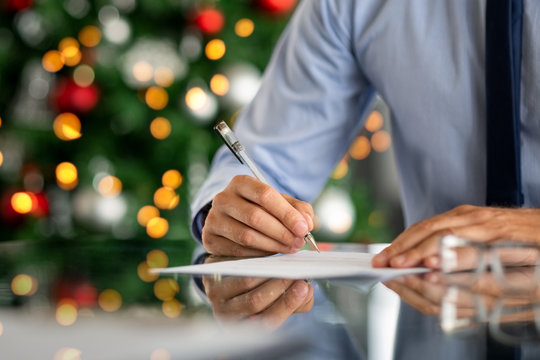 Businessman signing document during christmas time