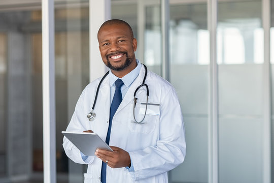 Portrait of happy african doctor at private clinic