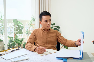 Portrait of young Asian architect man working at office