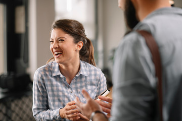 Business people in office talking. Beautiful businesswoman talking with colleagues.