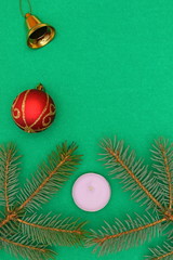 Merry christmas and a happy new year! A sprig of the green symbol of the winter holidays - spruce with decorations on a plain background and free space for an inscription.