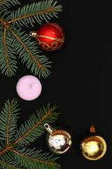 Merry christmas and a happy new year! A sprig of the green symbol of the winter holidays - spruce with decorations on a plain background and free space for an inscription.