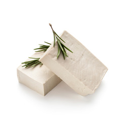 Fresh tofu blocks with rosemary branch, isolated on white