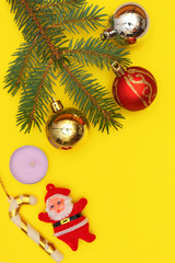 Merry christmas and a happy new year! A sprig of the green symbol of the winter holidays - spruce with decorations on a plain background and free space for an inscription.