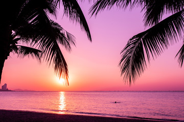 Plakat coconut tree at tropical coast, made with Vintage tones, and purple sky at the sunset ,warm tones