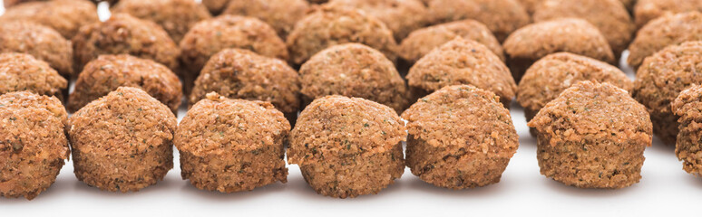 close up view of fresh cooked falafel balls on white background, panoramic shot