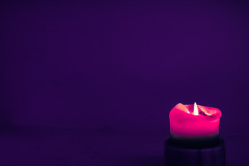 Pink holiday candle on purple background, luxury branding design and decoration for Christmas, New Years Eve and Valentines Day
