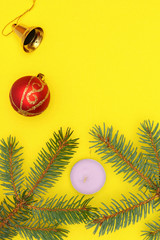 Merry christmas and a happy new year! A sprig of the green symbol of the winter holidays - spruce with decorations on a plain background and free space for an inscription.