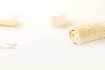 Mock up of bath products: bottles for shampoo (shower gel, lotion, oil), towel, cotton buds on white background. Close up, copy space for text. Concept of baby bath accessories. Morning skin care