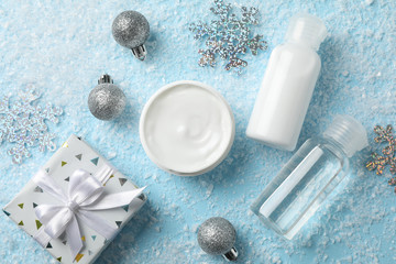 Fototapeta na wymiar Set cosmetics, jar of winter cream for skin on snowy blue background, closeup. Top view