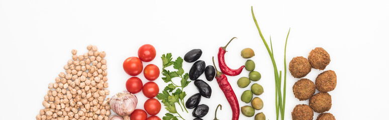 top view of chickpea, garlic, cherry tomatoes, parsley, olives, chili pepper, green onion and falafel on white background, panoramic shot