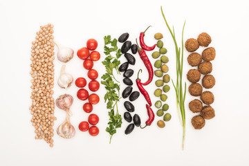 top view of chickpea, garlic, cherry tomatoes, parsley, olives, chili pepper, green onion and falafel on white background