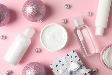 Set cosmetics, winter cream for skin, gift box on pink background, closeup. Top view