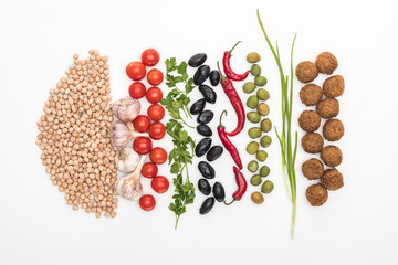 top view of chickpea, garlic, cherry tomatoes, parsley, olives, chili pepper, green onion and falafel on white background