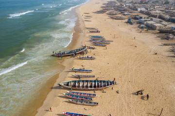Aerial view of fishing village, pirogues fishing boats in Kayar, Senegal.  Photo made by drone from...