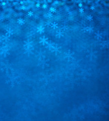 Blue snowflakes bokeh abstract background.