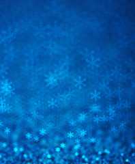 Blue snowflakes bokeh abstract background.