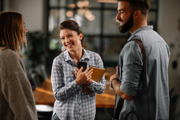 Colleagues having fun in office. Business people talking at workplace. 