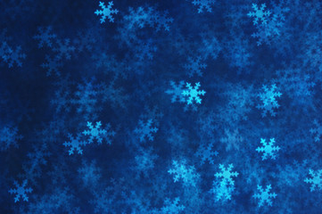 Fototapeta na wymiar Blue snowflakes abstract winter background.