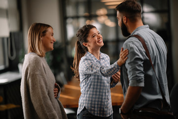 Colleagues having fun in office. Business people talking at workplace. 