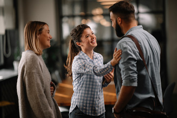 Colleagues having fun in office. Business people talking at workplace. 