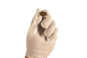 Hand in white glove holds one bullet in fingers. Isolated closeup on white background. Concept of crime investigation, ballistics or arms and gun shop. Clue proof in expert hand