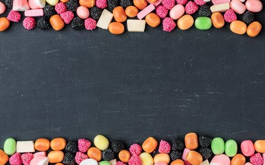 frame of multi-colored candies on a dark background with copy space - 305420390