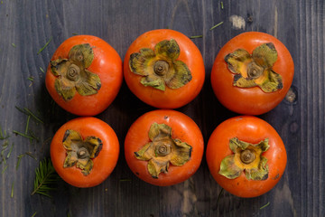 orange persimmon on a wooden background. Top view