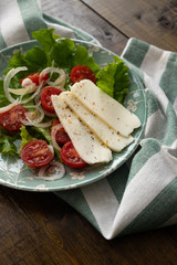 vegetarian food. Vegetable salad with cheese and spices. Wood background